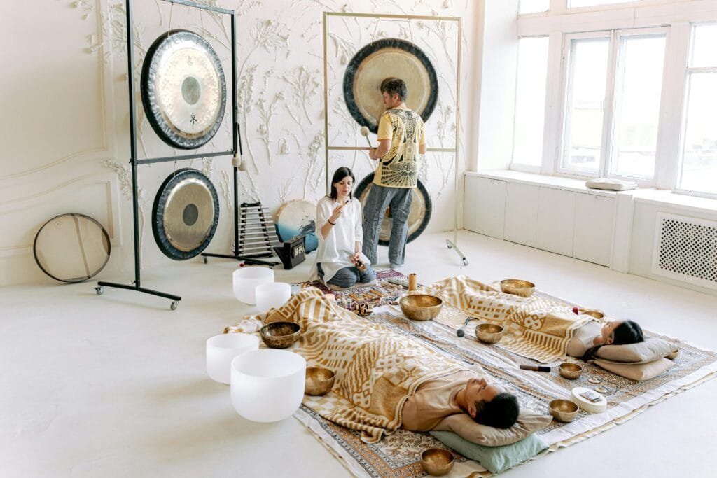 A serene indoor sound bath session with gongs and singing bowls promoting relaxation and wellness.